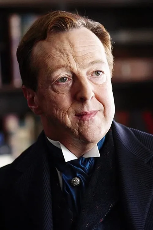 Edward Hibbert interpretando a Richard Grayson